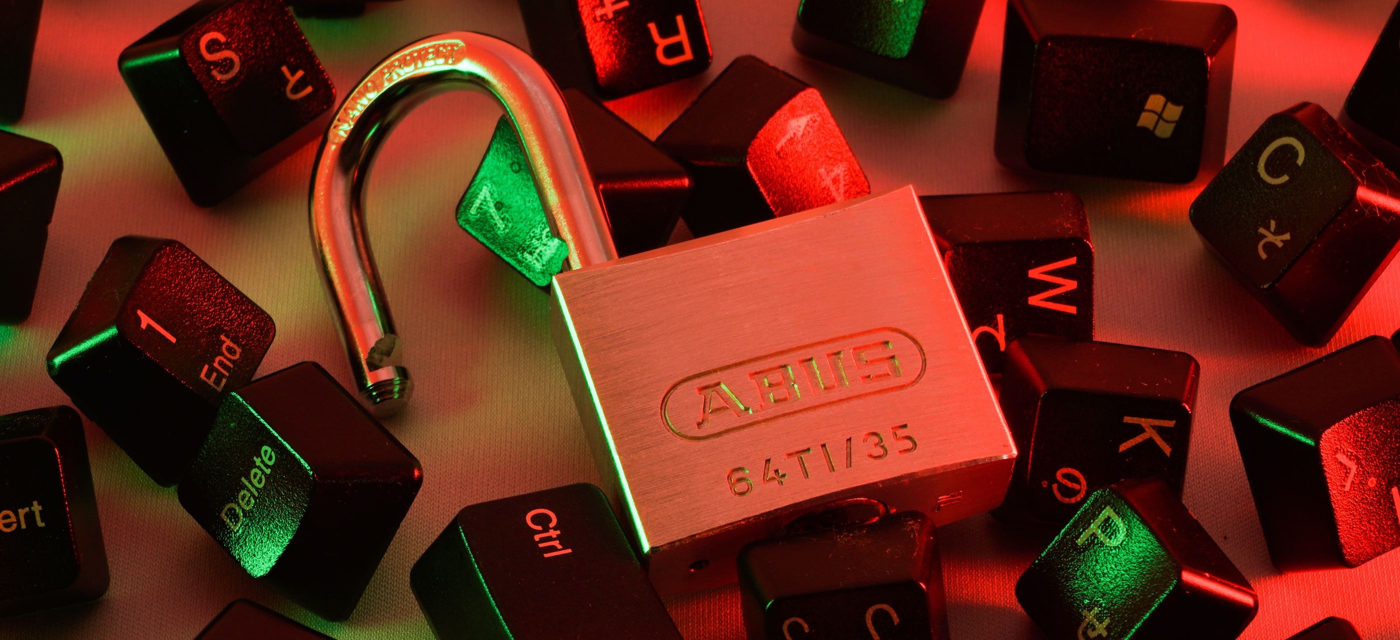 An image of some scattered keyboard keys and a padlock to suggest computer security